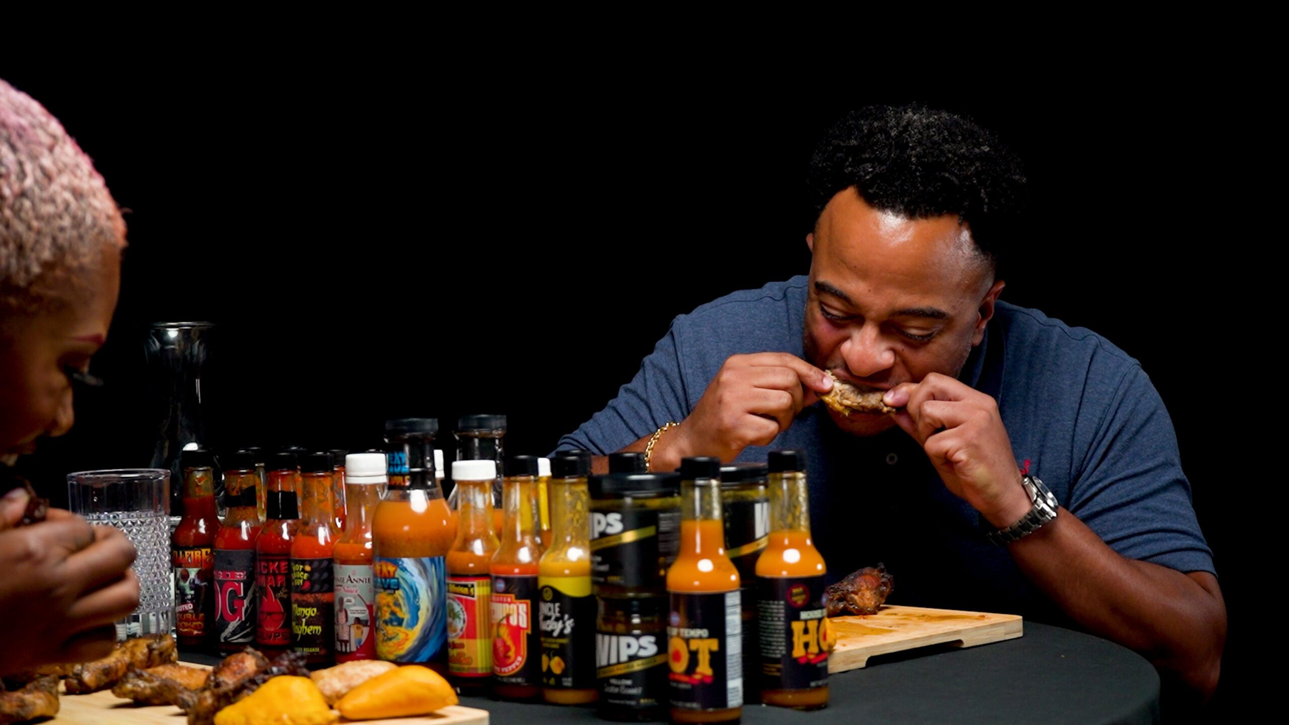 Steven Clarke biting into spicy wings